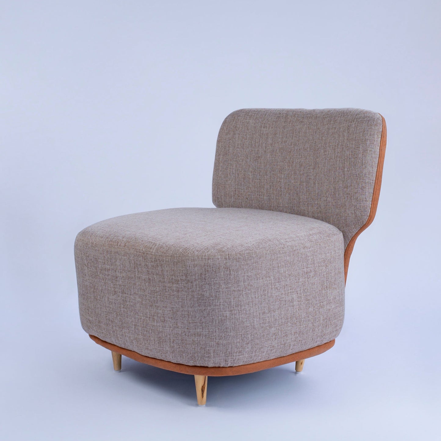 Gray upholstered chair with wooden legs on a light gray background The Seating Company 