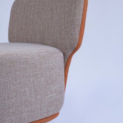 Gray upholstered chair with wooden armrests on a light gray background The seating Company 